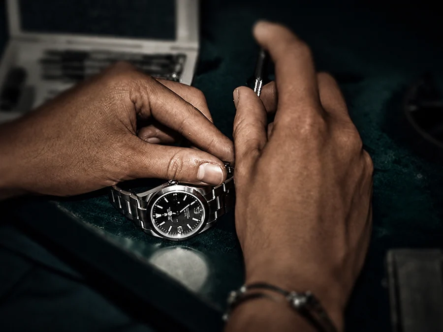 Watchmaker adjusting a watch during authentication