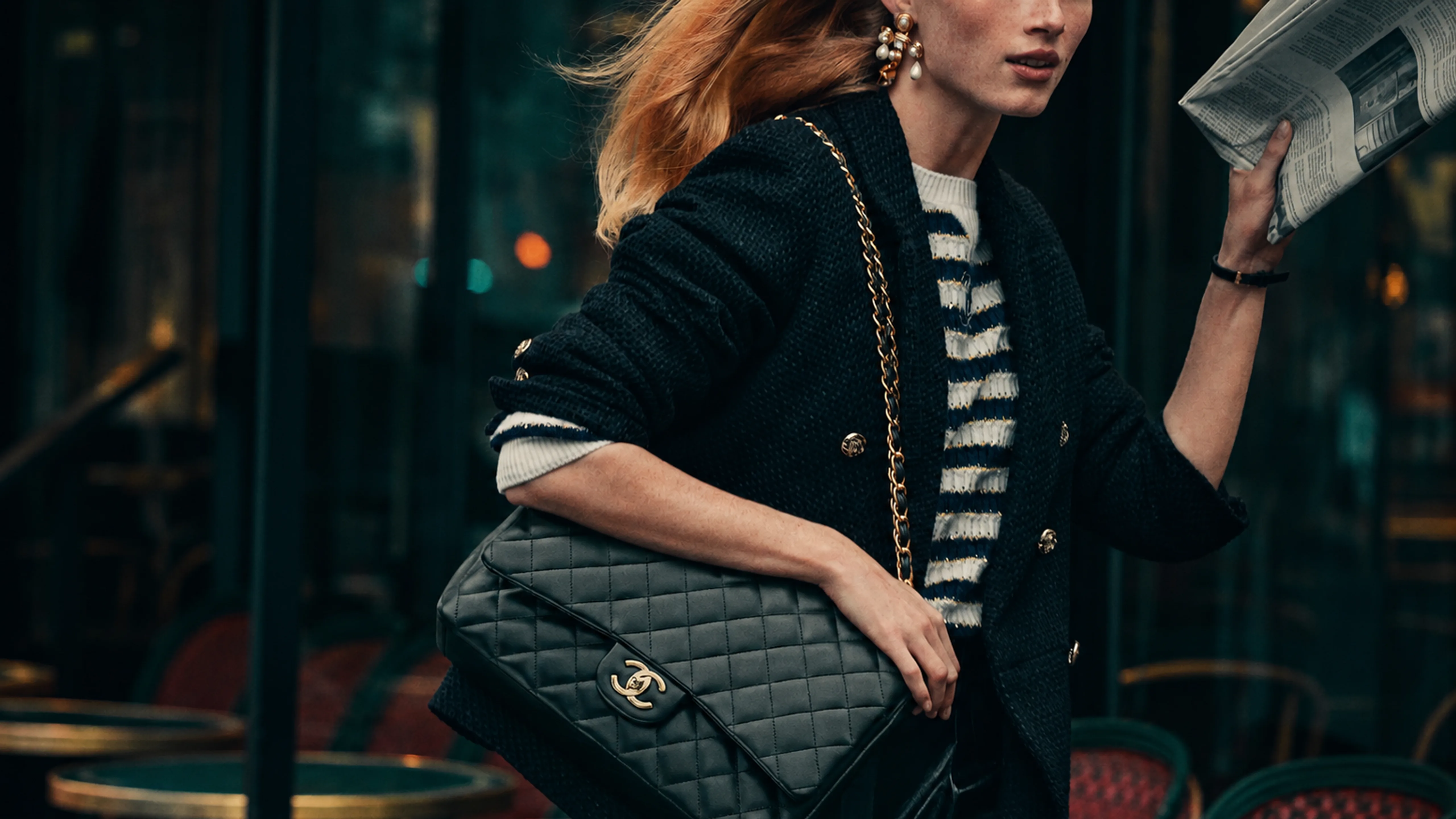 Chanel bag worn on the shoulder, city scene